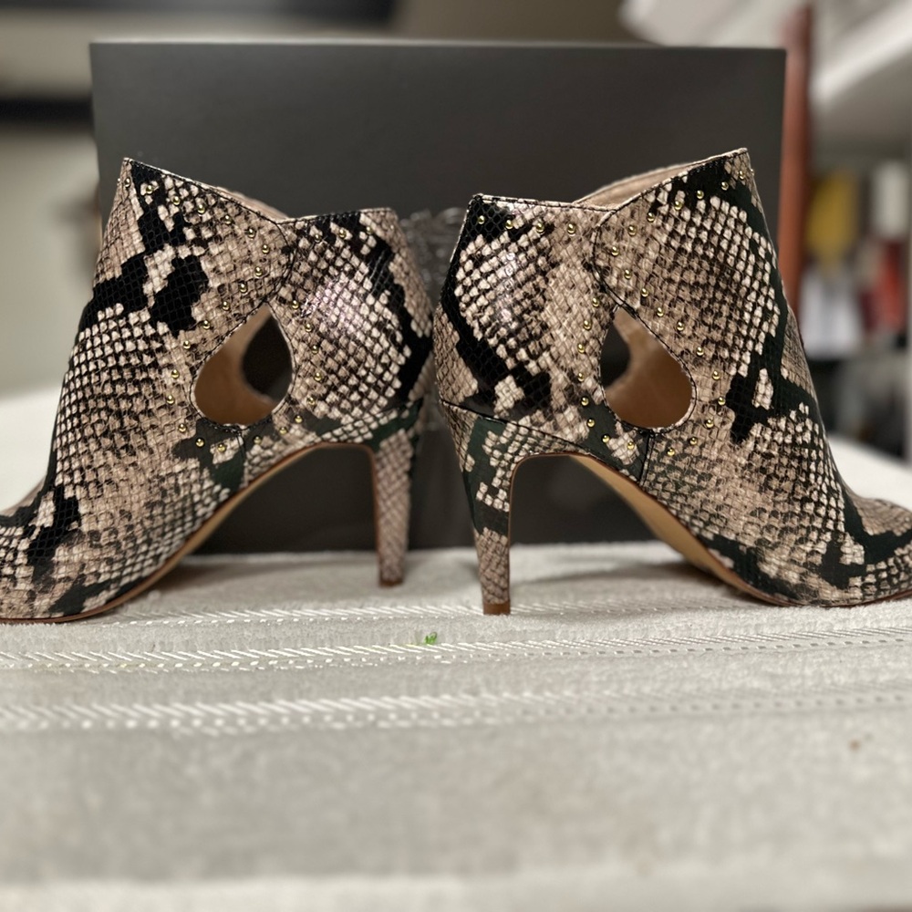 #61 women heels that are a size 8m and a snake pattern on the shoe.